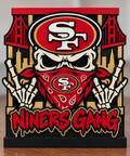 49ers Niners Gang candle holder with skull, SF-emblem bandana, skeletal hands, bridge details, and red top tray.