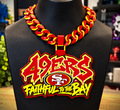 Red-and-yellow 49ers graffiti hype chain with SF emblem and Faithful to the Bay lettering on a black display bust.