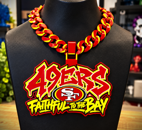 Red-and-yellow 49ers graffiti hype chain with SF emblem and Faithful to the Bay lettering on a black display bust.
