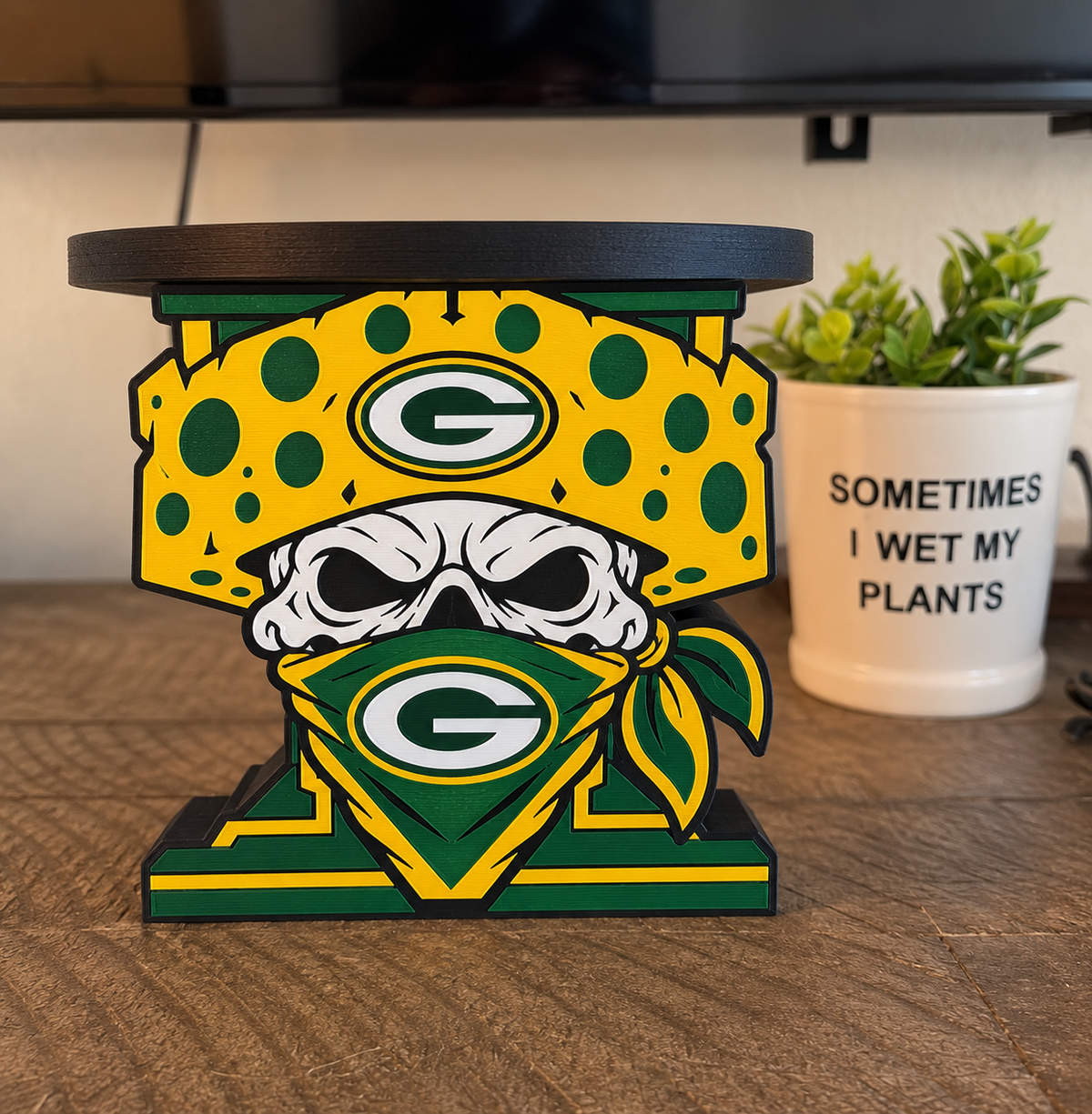 Green Bay Packers candle holder with a skull, yellow cheese-style hat, green bandana, and black circular top tray.