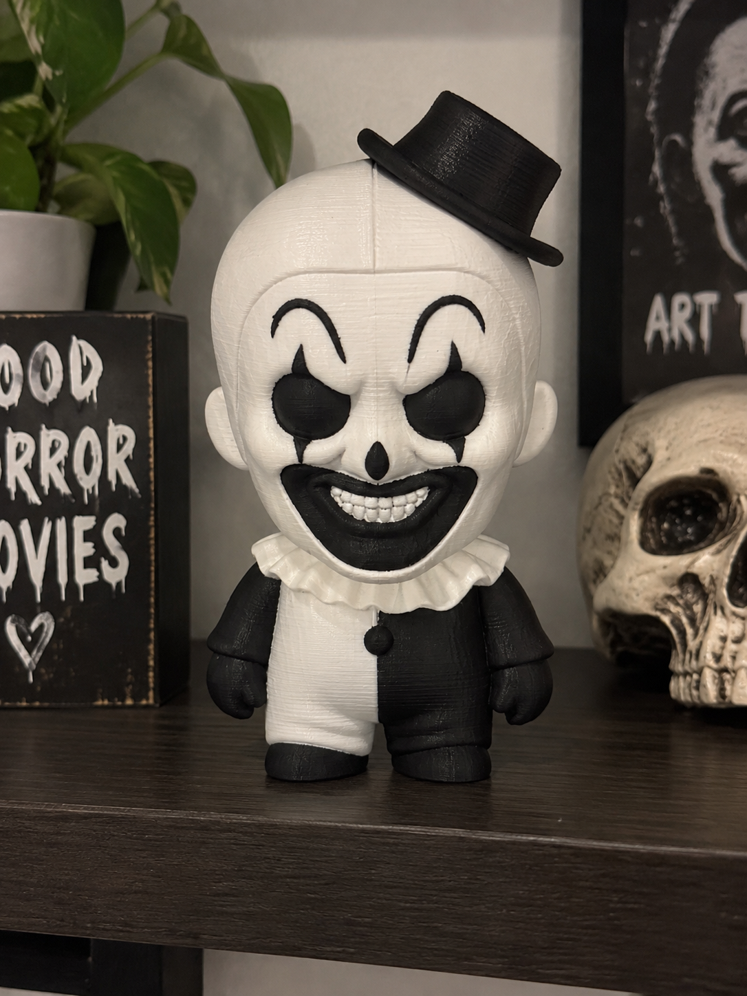 Art the Clown micro statue preview with a tilted black top hat, wide grin, and black-and-white outfit.