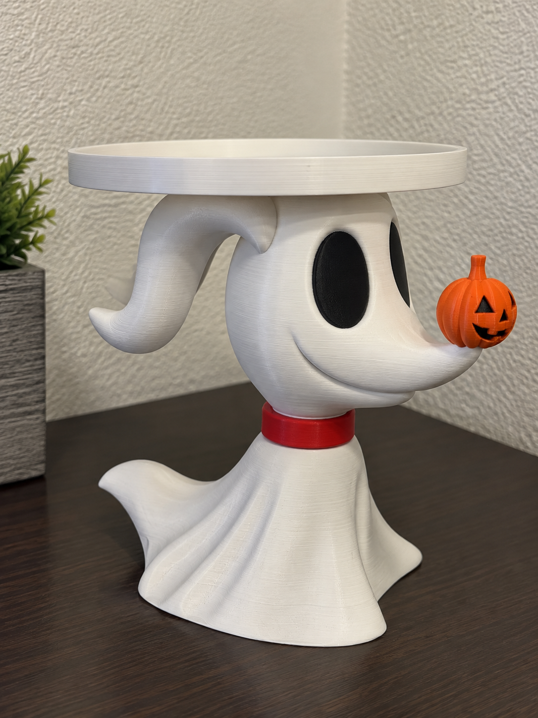 White Zero ghost-dog candle holder with red collar, orange pumpkin nose, and raised white circular tray.