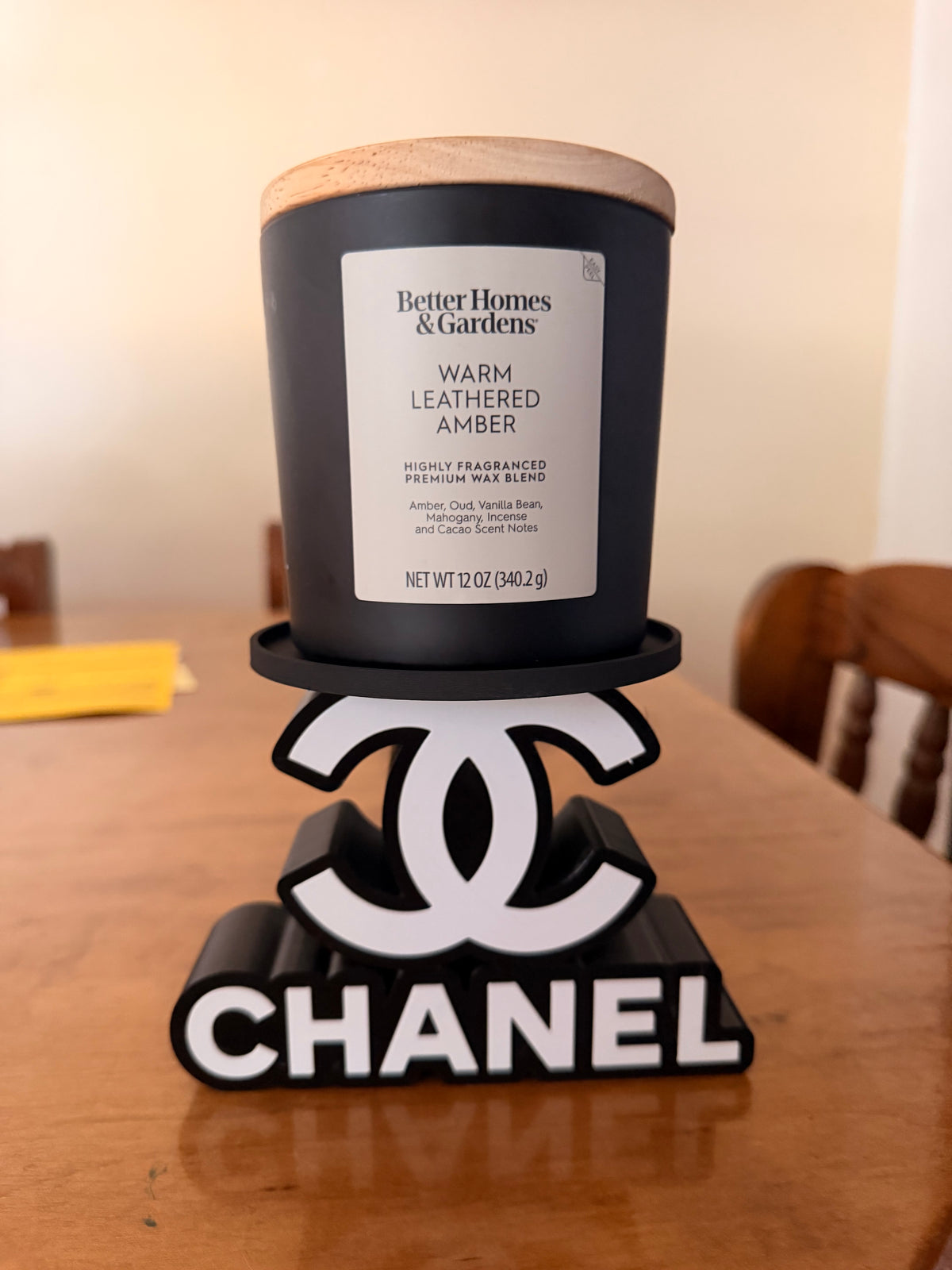 Black-and-white Chanel candle holder with a double-C motif and lettering base; wax candle pictured, but holder is for flameless LED candles only.