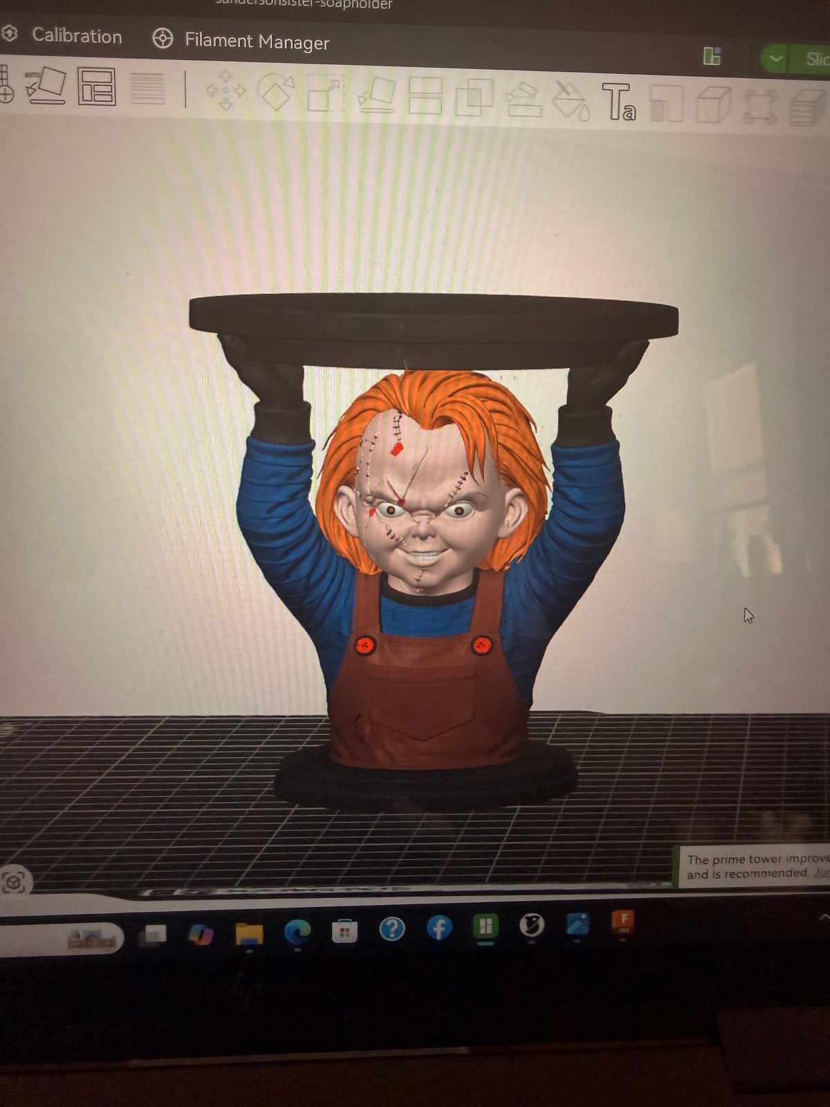 Digital model preview in slicing software of Chucky holding a circular candle tray overhead; not a finished-product photograph.