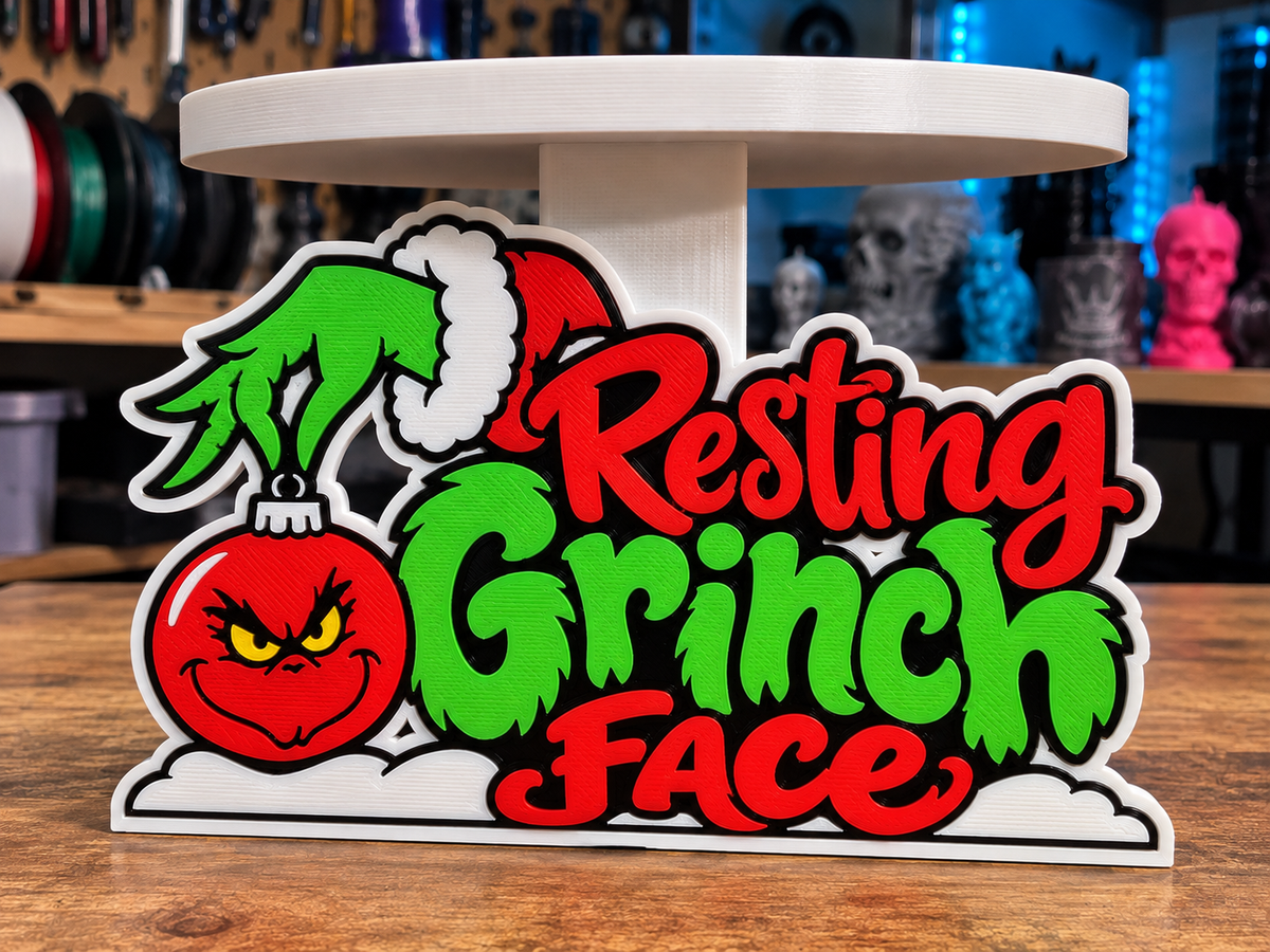Resting Grinch Face candle holder design with red and green lettering, Santa hat and Grinch ornament