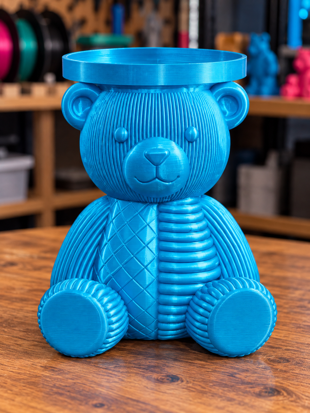 Teal 3D-printed seated bear candle holder with textured body and round tray above its head