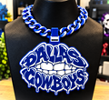 Blue-and-white Dallas Cowboys Lip hype chain with teeth and dripping graffiti-style lettering on a black display bust.