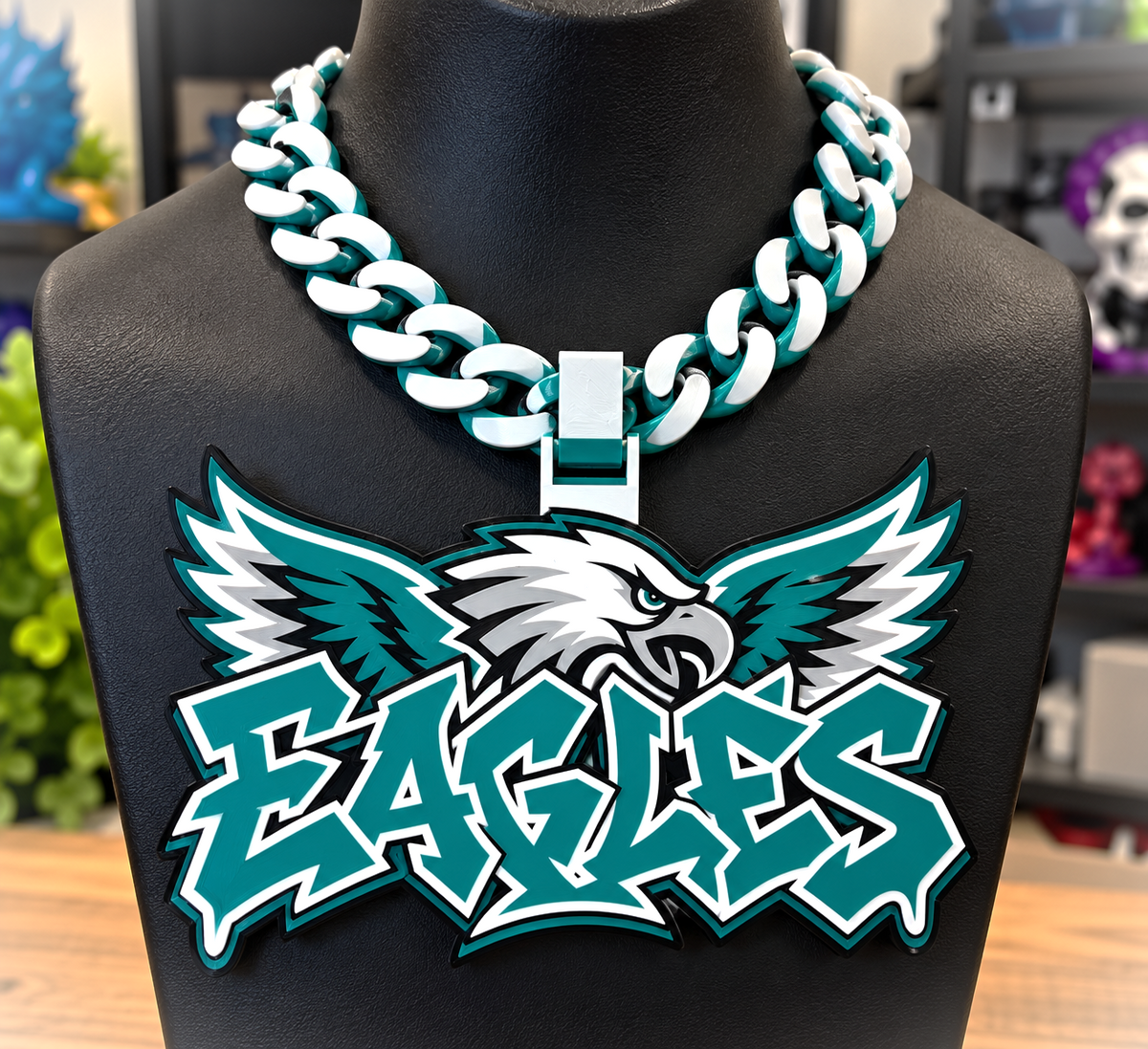 Philadelphia Eagles Graffiti hype chain with a winged eagle and teal lettering on a black display bust.