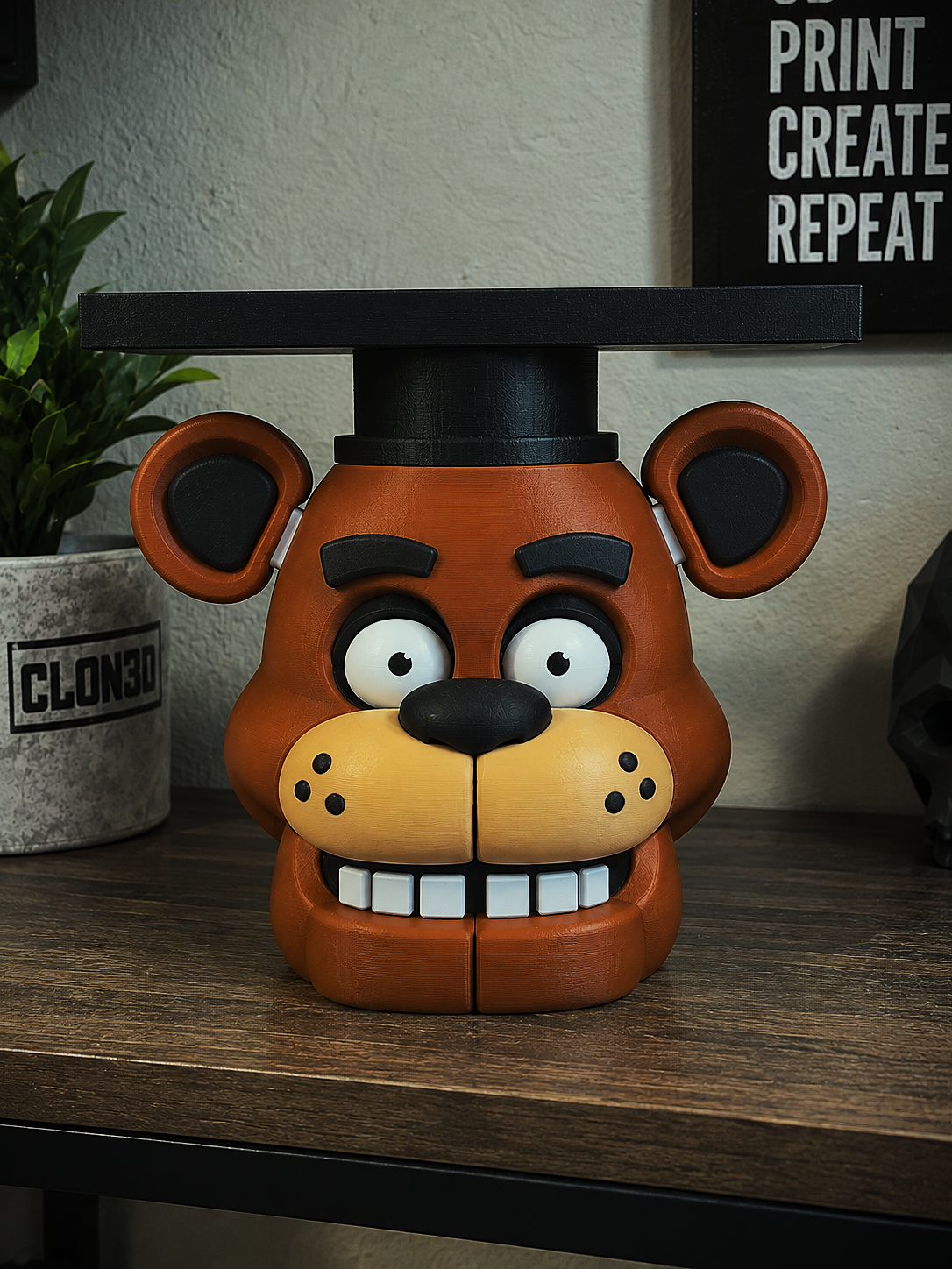 Freddy Fazbear candle holder with a brown bear face, golden muzzle, and black top hat supporting a raised tray.