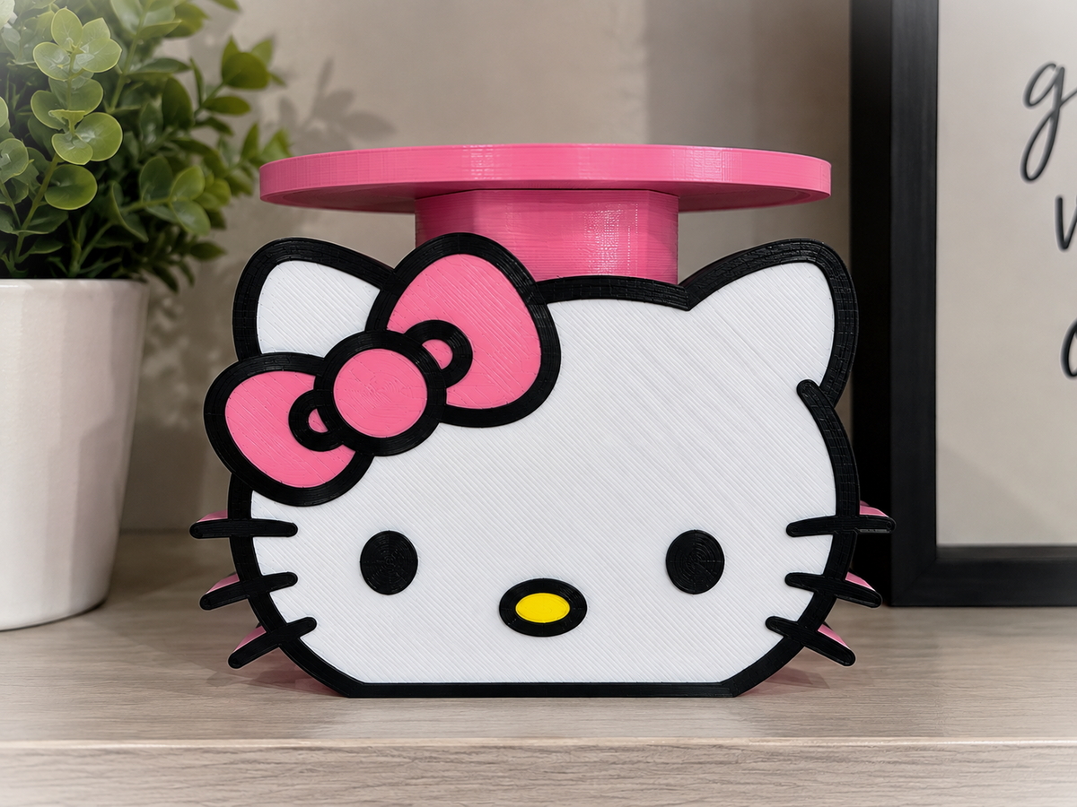 Hello Kitty candle and soap holder with a pink bow, white face, and raised pink circular tray on a shelf.