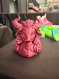 Lilith Duck figurine preview with sweeping horns, flowing hair, and ornate details in a reddish-pink finish.