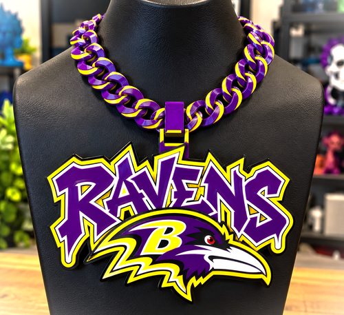 Baltimore Ravens Graffiti hype chain with purple lettering and a raven-head emblem outlined in yellow and white on a black display bust.