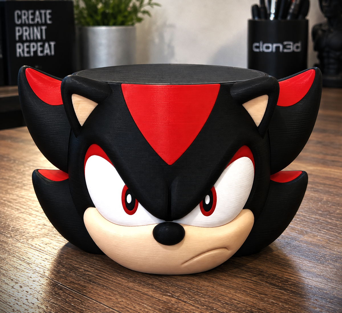 Shadow the Hedgehog candle holder with black spikes, red accents, and a circular black top on a wooden table.