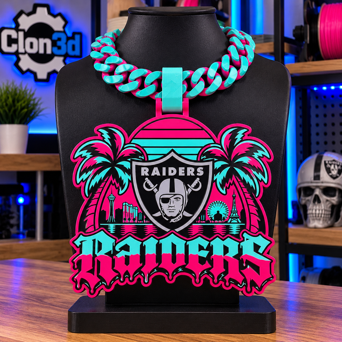 Las Vegas Raiders Vice hype chain in pink and teal with Raiders shield, palm trees, sunset, and skyline on a black display bust.
